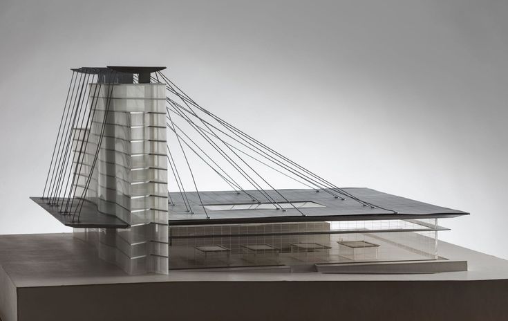 a model of a building with a bridge in the background