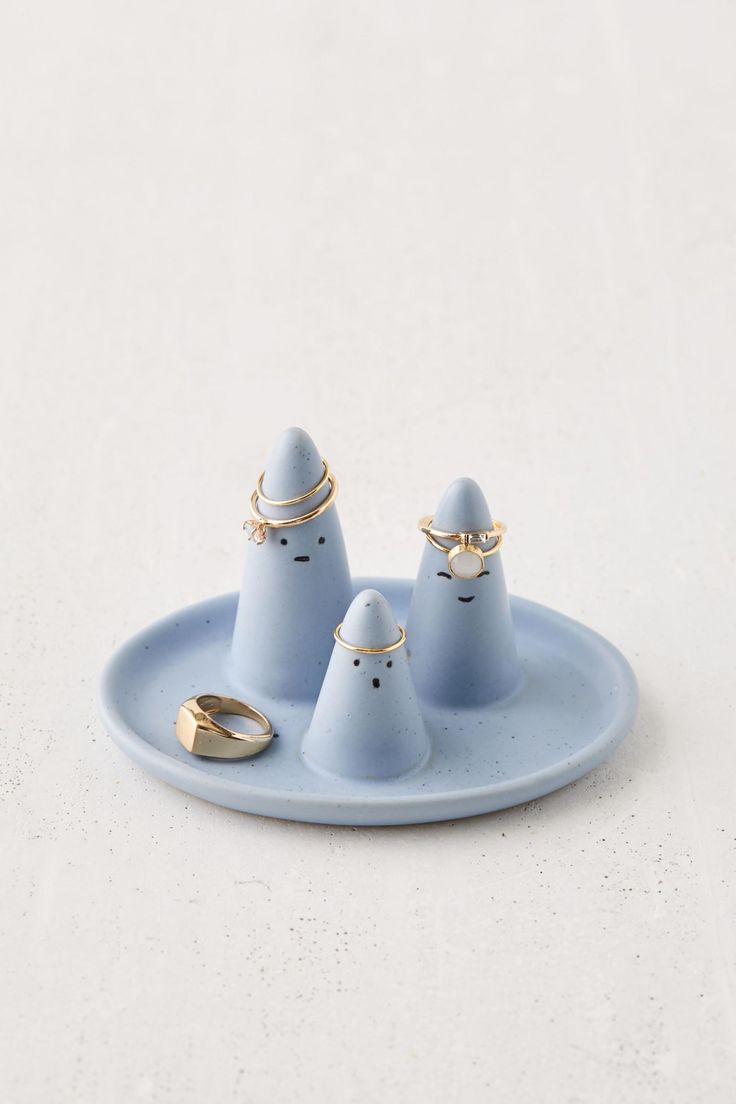 three small blue objects sitting on top of a plate