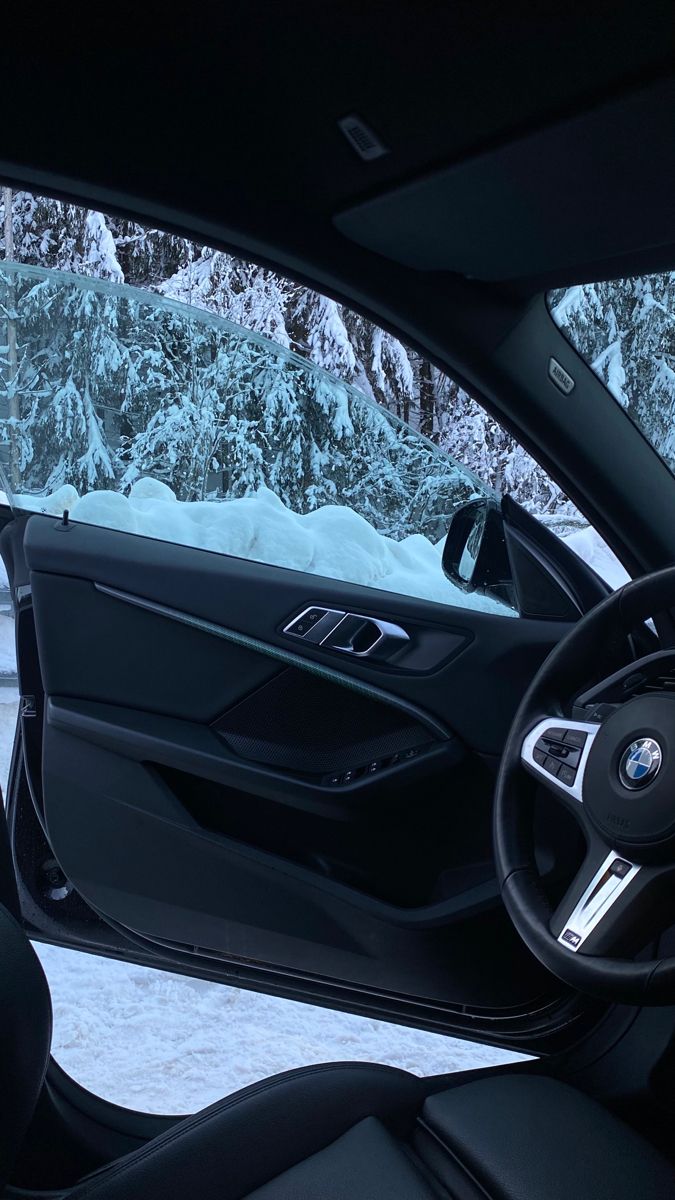 the interior of a car with snow covered mountains in the background