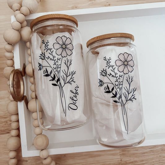 two glass jars with flowers painted on them