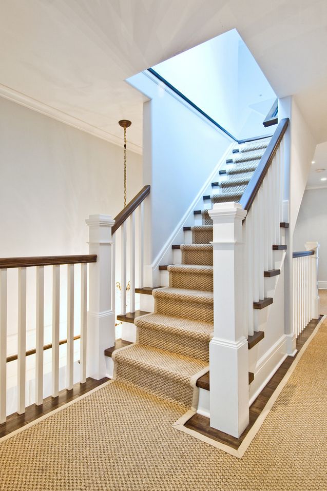 a staircase leading up to the second floor in an empty room with carpeted floors