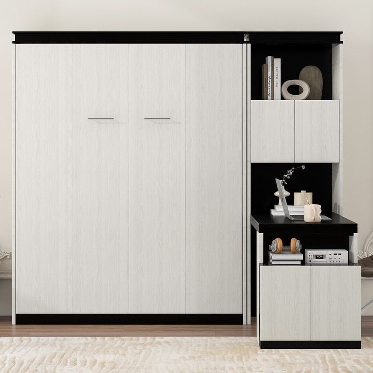 a living room with white furniture and black accents