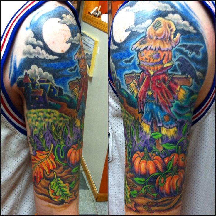 a man with a full sleeve tattoo on his arm and shoulder is holding a pumpkin