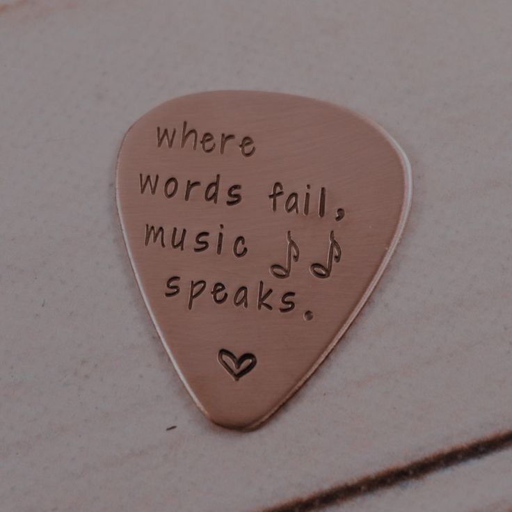 a guitar pick with words written on it