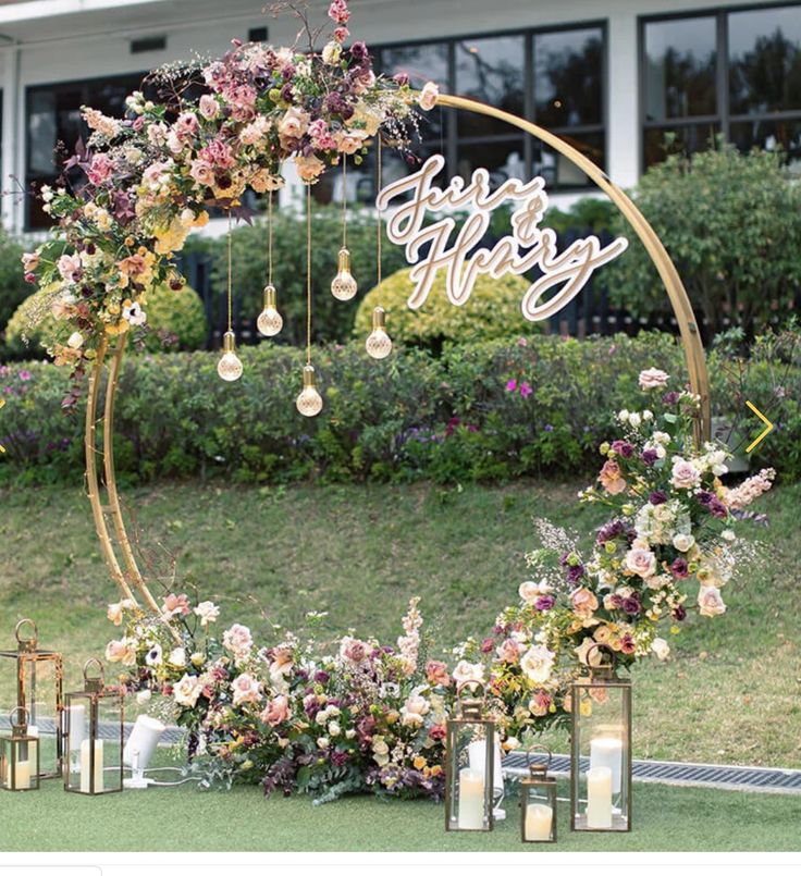 a wedding arch decorated with flowers and candles