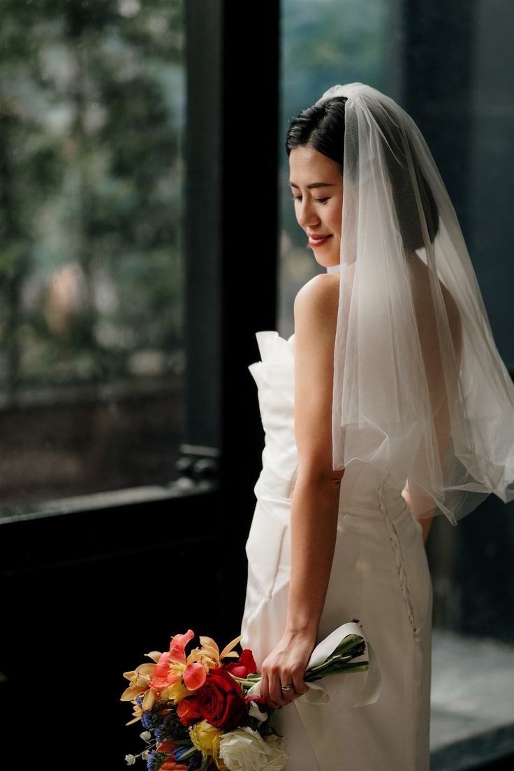 a woman in a wedding dress holding a bouquet