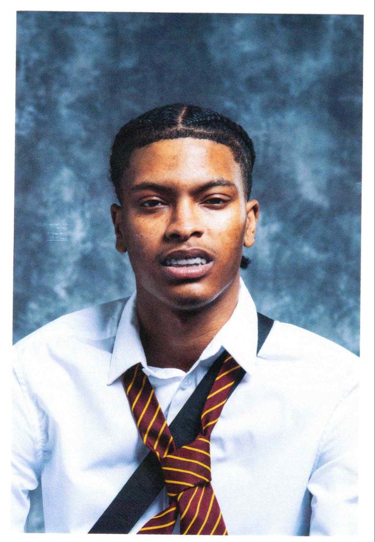 a young man wearing a tie and white shirt