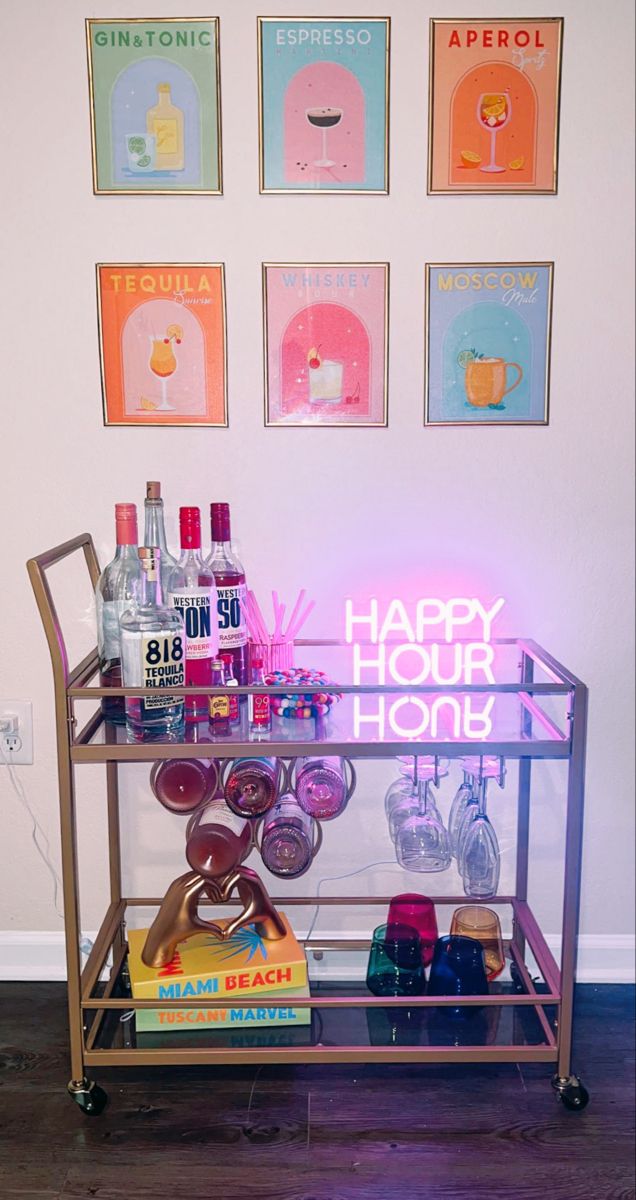 a bar cart with bottles and glasses on it