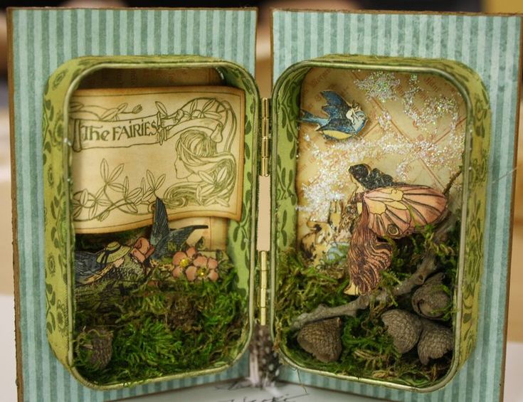 an open book with fairy figurines in it