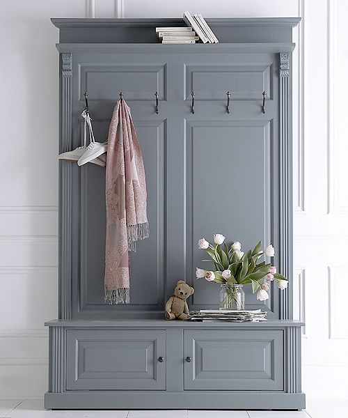 a blue cabinet with some flowers on it and a pink scarf hanging from the door