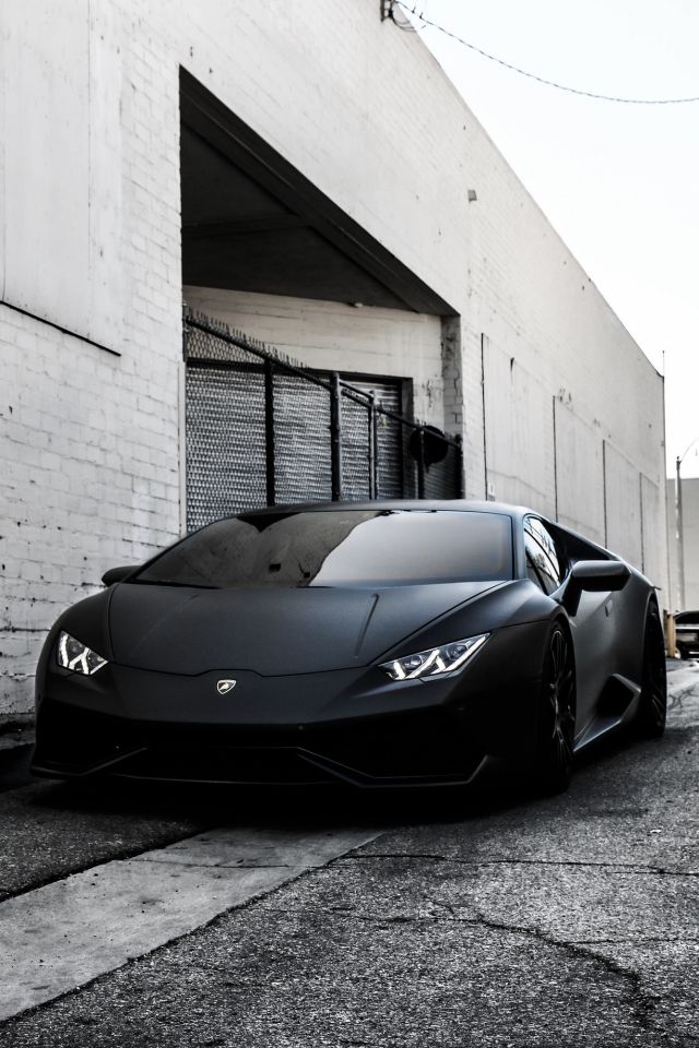 a black sports car parked in front of a building