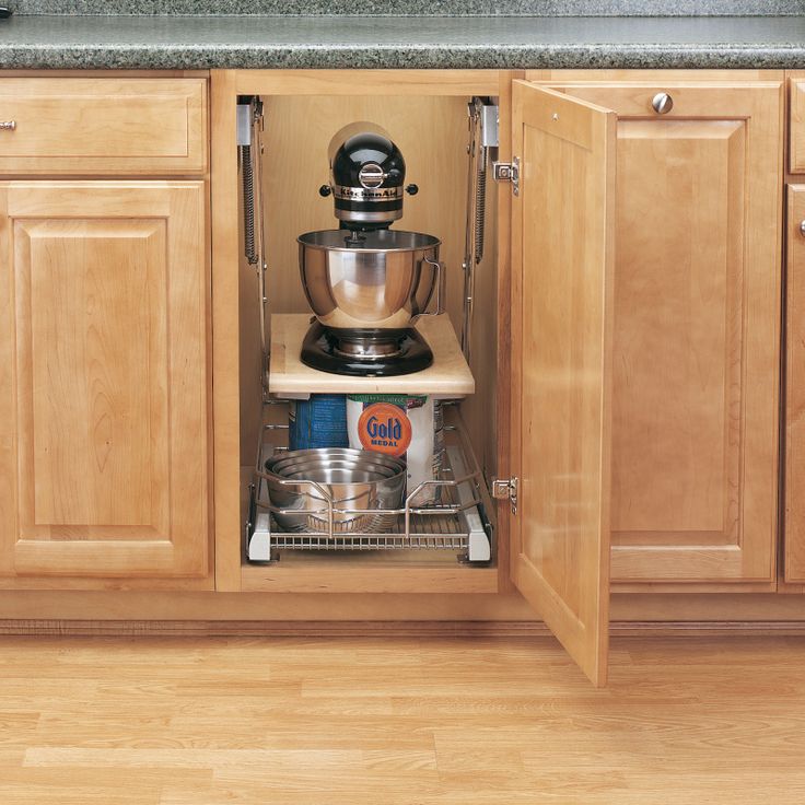 an open cabinet with pots and pans in it