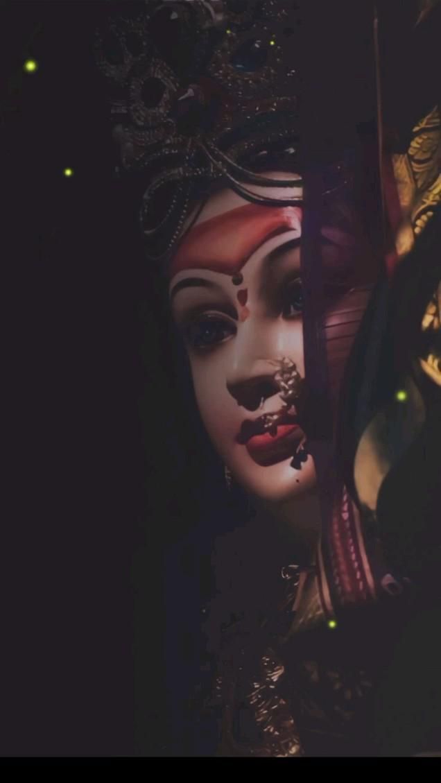 a close up of a woman's face with makeup and jewelry on her head