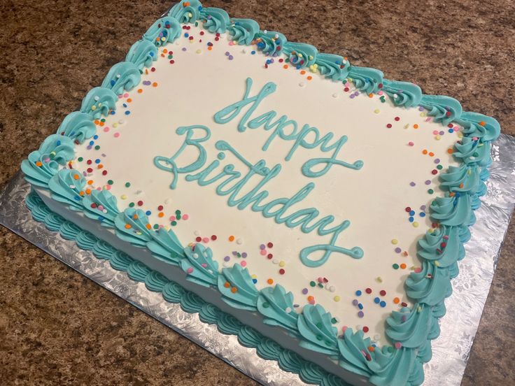 a birthday cake with blue frosting and sprinkles