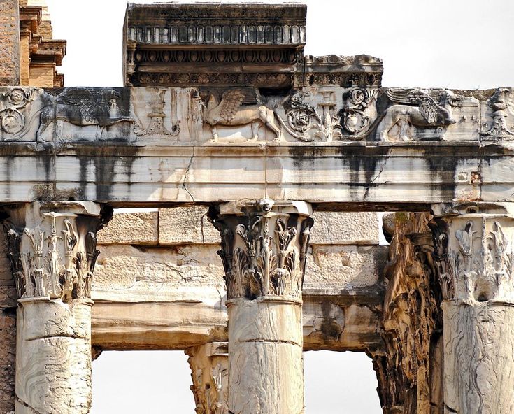 an ancient building with many columns and carvings