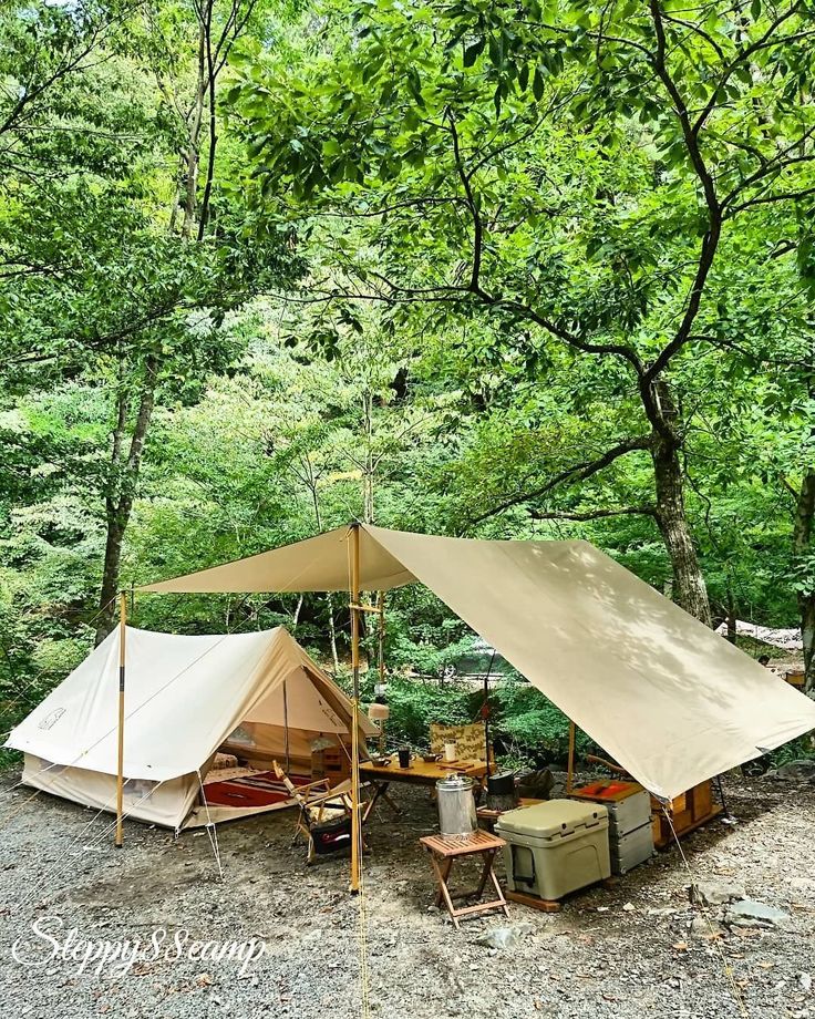 a tent is set up in the woods