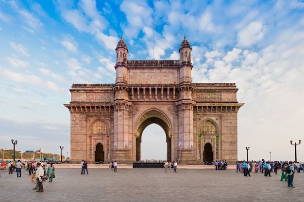 people are walking around in front of the gateway to india