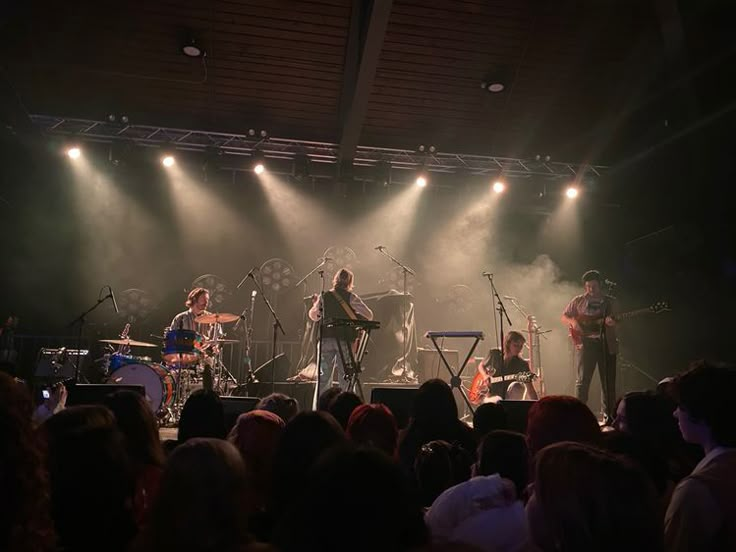 a group of people that are on stage with some microphones in front of them