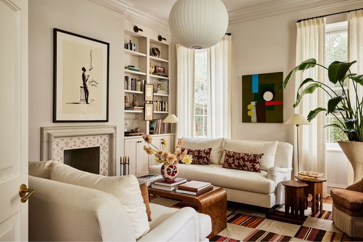 a living room filled with furniture and a fire place in front of a window next to a fireplace