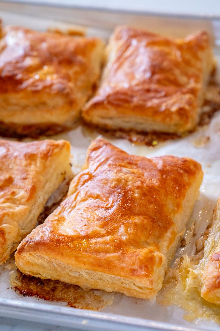 several pieces of pastry sitting on top of a pan