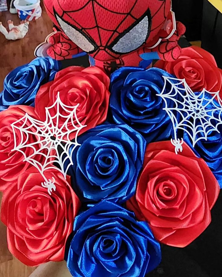 a bouquet of red, white and blue flowers with a spiderman face on it