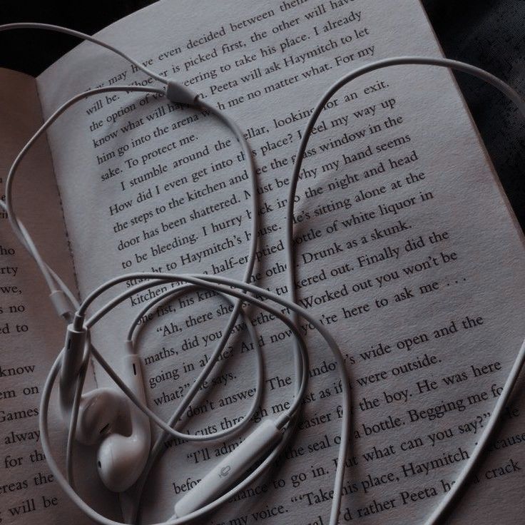 headphones laying on top of an open book