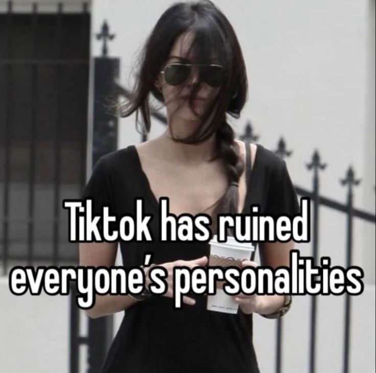 a woman in black shirt holding a cell phone with text that reads tiktok has ruined everyone's personalities