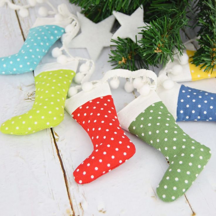 polka dot stockings are hanging from the christmas tree