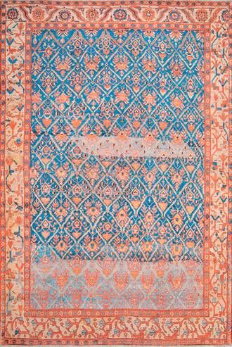 an antique rug with blue and orange colors