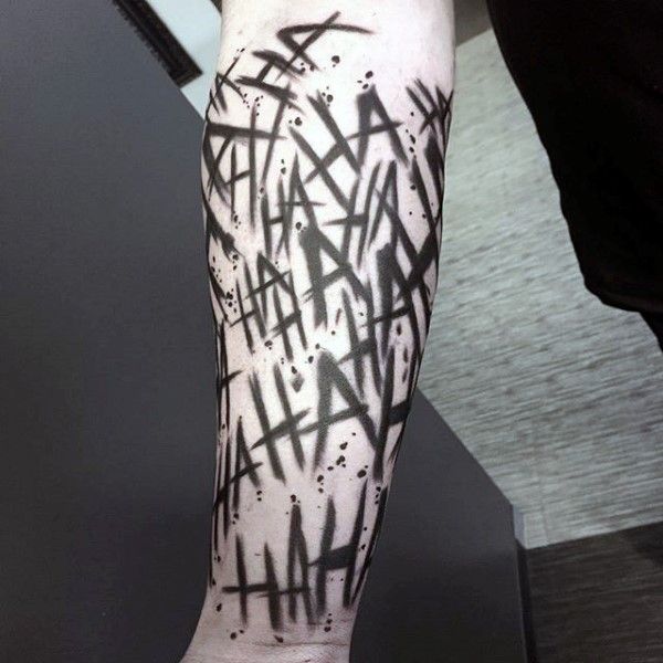 a man's leg with black and white graffiti on it