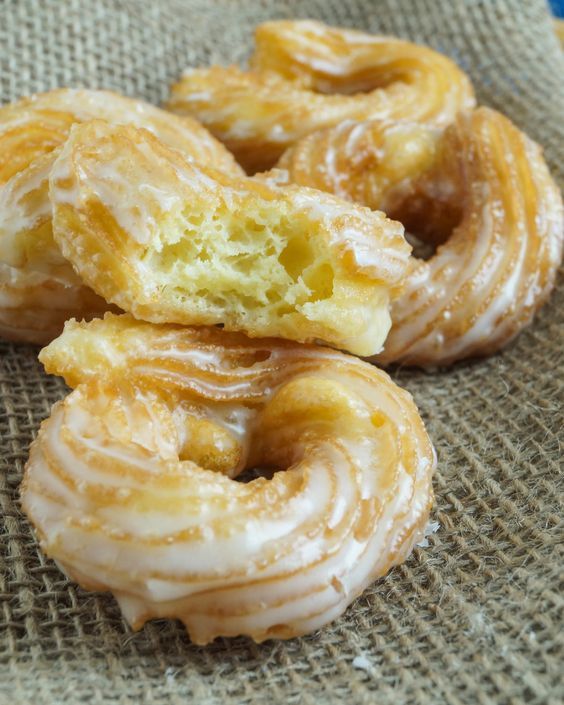 several glazed doughnuts sitting on top of a cloth