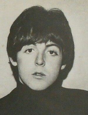 an old black and white photo of a young man in a turtle - neck sweater