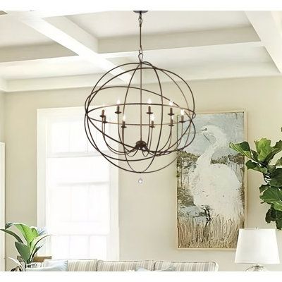 a living room filled with furniture and a chandelier hanging over the couches