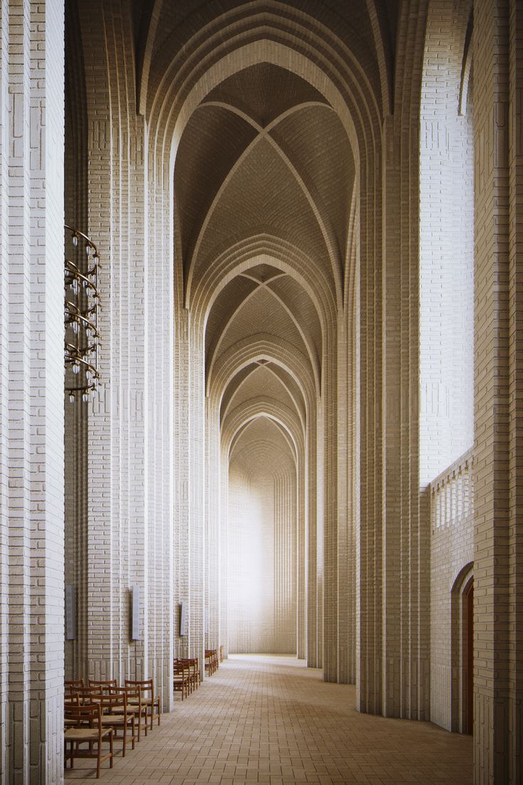 the interior of a cathedral with rows of pews and benches lined up against the wall