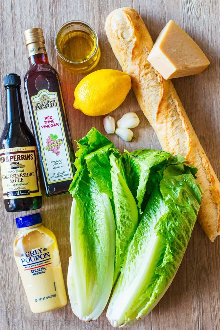 lettuce, bread, mustard, garlic and other ingredients on a table top