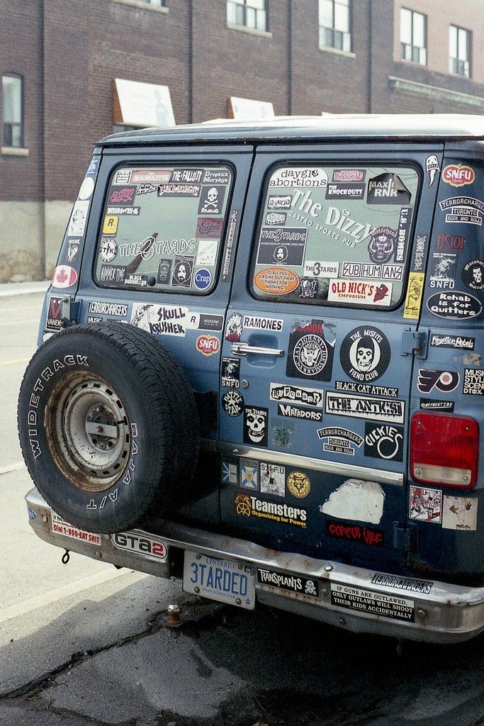 the back end of a truck with stickers all over it