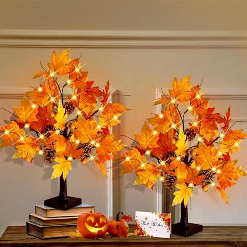 two vases with leaves and pumpkins are on a table next to each other