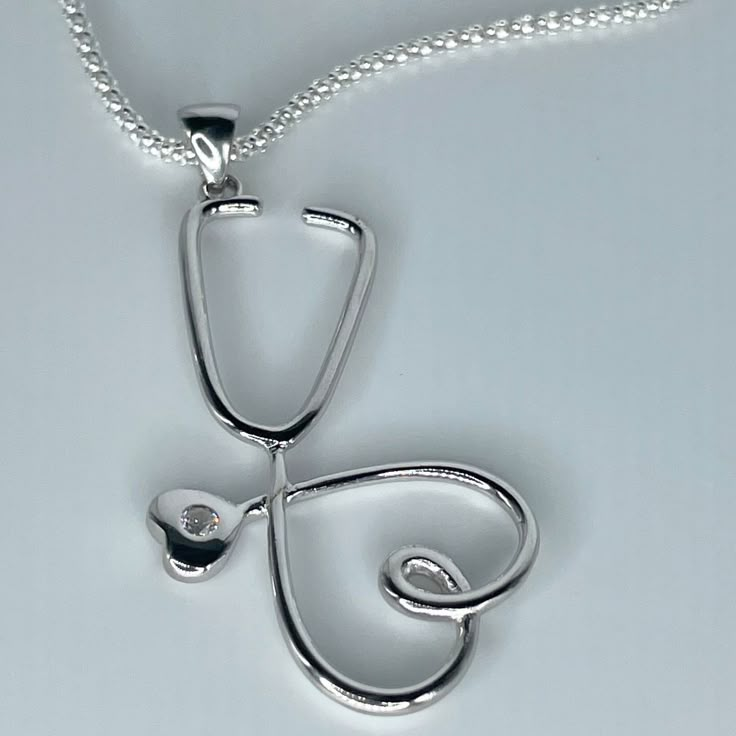 *  Sterling Silver Large Heart Stethoscope Pendant Necklace, Heart Promise Necklace, Silver Love Necklace, Nurse Heart Jewelry, Stethoscope Necklace, Frontline Worker Jewelry, Silver CZ Pendant, Nurse Necklace, Doctor Necklace, Hospital Staff. 925 Stamped *  Perfect gift idea for any occasion: birthday, anniversary, engagement, graduation, bridesmaid, Mother's Day, Valentine's Day, Christmas, Graduation Gift, promise. *  Stethoscopes symbolize a nurse's commitment to care for his patients' healt Cf Lung Necklace, Greys Anatomy Necklace, Stethoscope Pendant, Mother Day Jewelry, Doctor Necklace, Nurse Necklace, Doctor Jewelry, Heart Stethoscope, Silver Leaf Bracelet