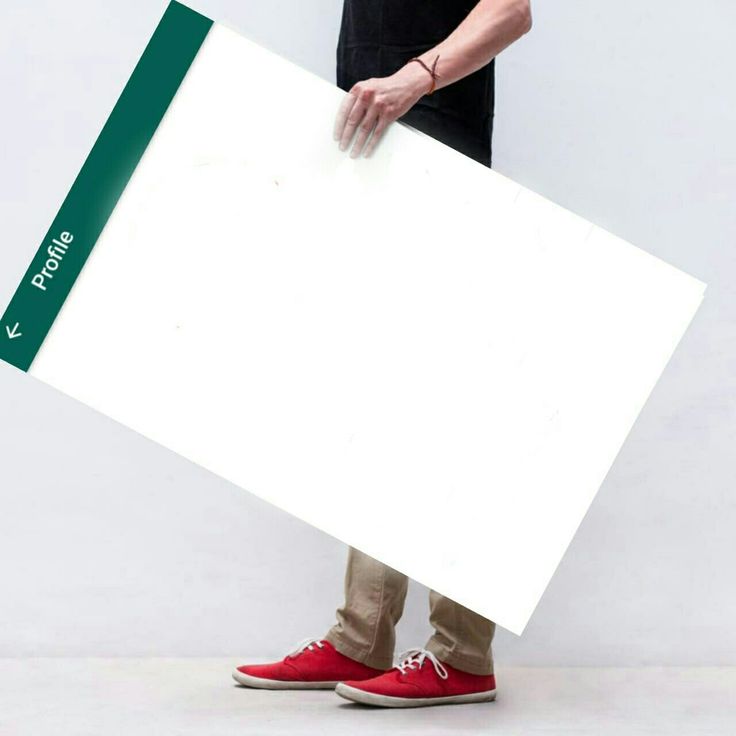 a person in red shoes holding a large white board