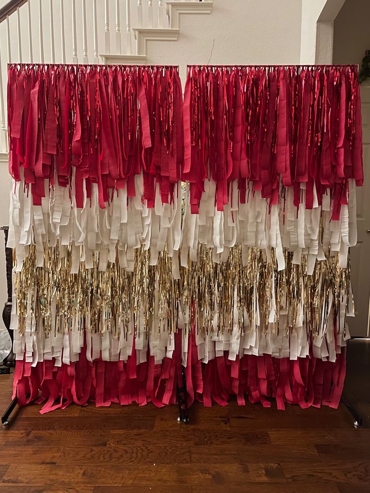 red, white and gold streamers hanging from the banister