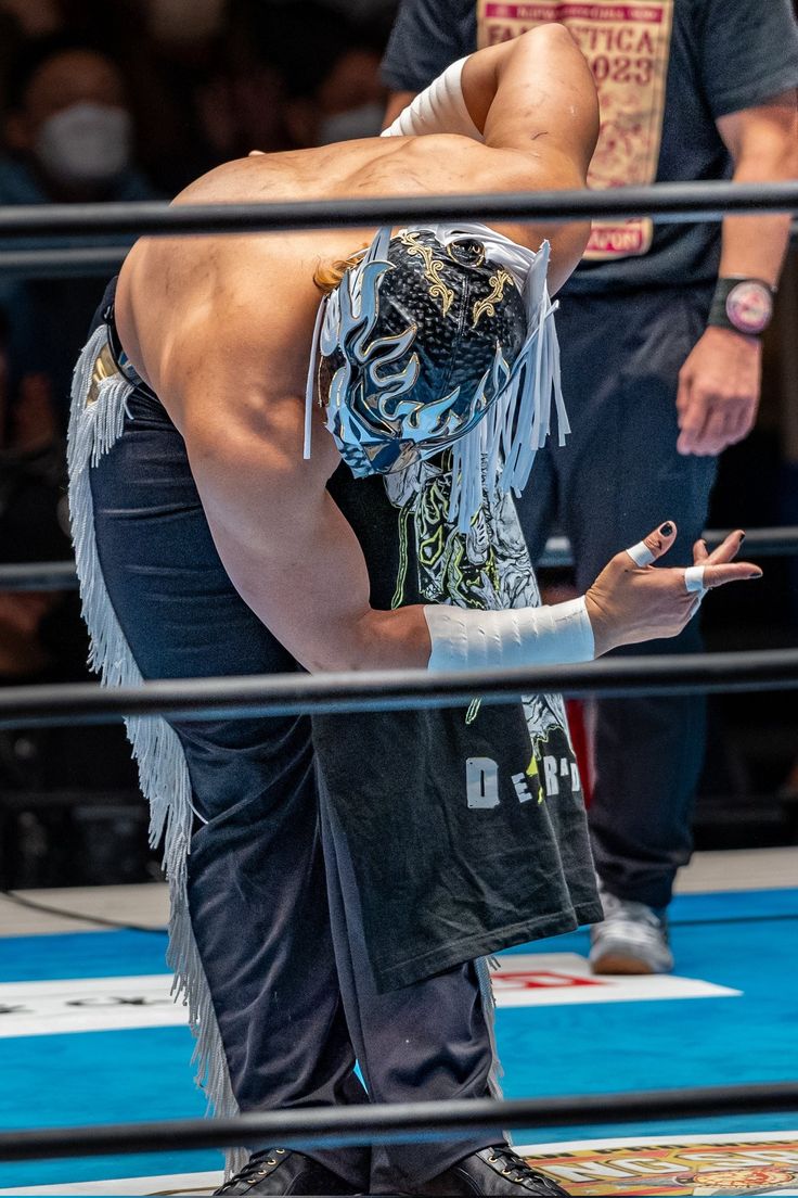 the wrestler is looking down at his opponent