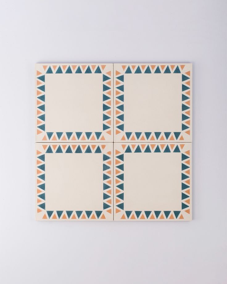 an orange, blue and white tile with triangles on it