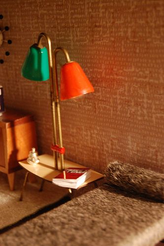 a room with a bed and two lamps on the wall