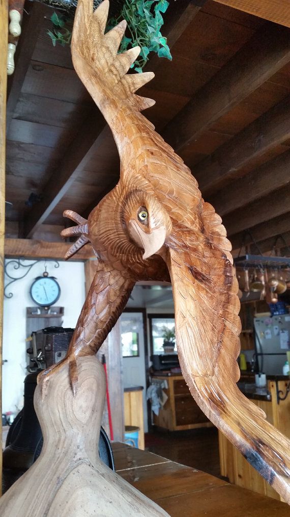 an owl statue on top of a wooden table