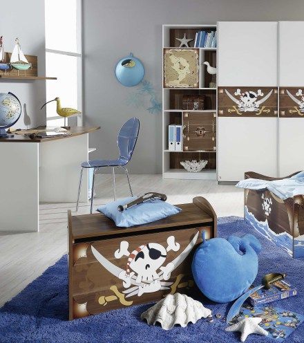 a child's bedroom decorated in blue and white with pirate themed decor on the walls