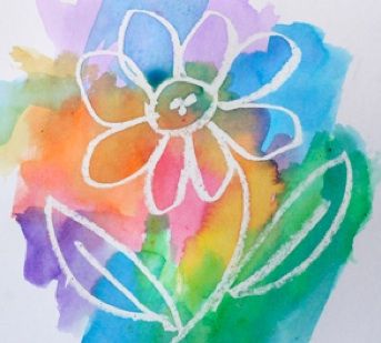 a watercolor drawing of a flower on a piece of white paper with colored ink