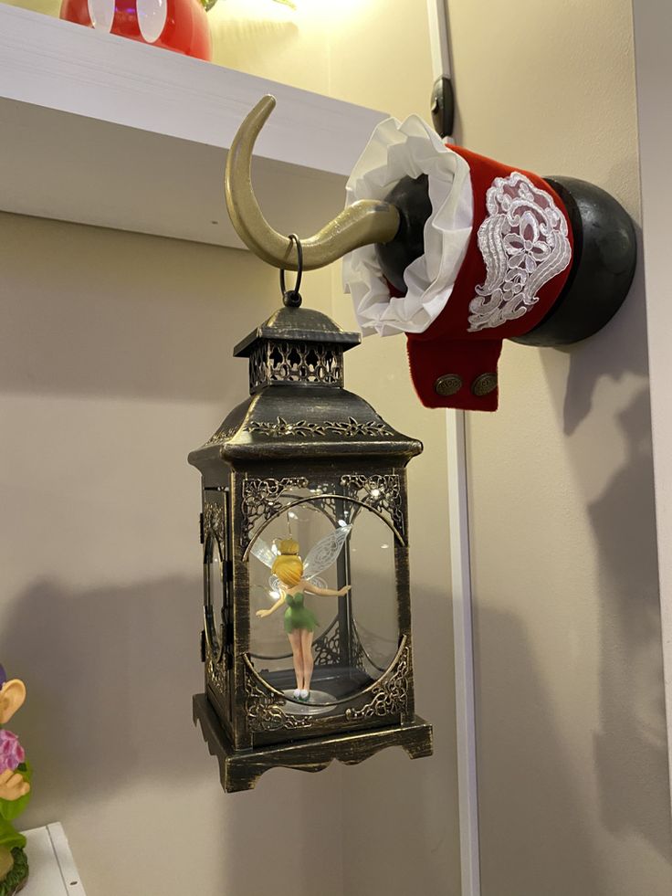 an elephant head hanging from the side of a wall next to a clock with a woman on it