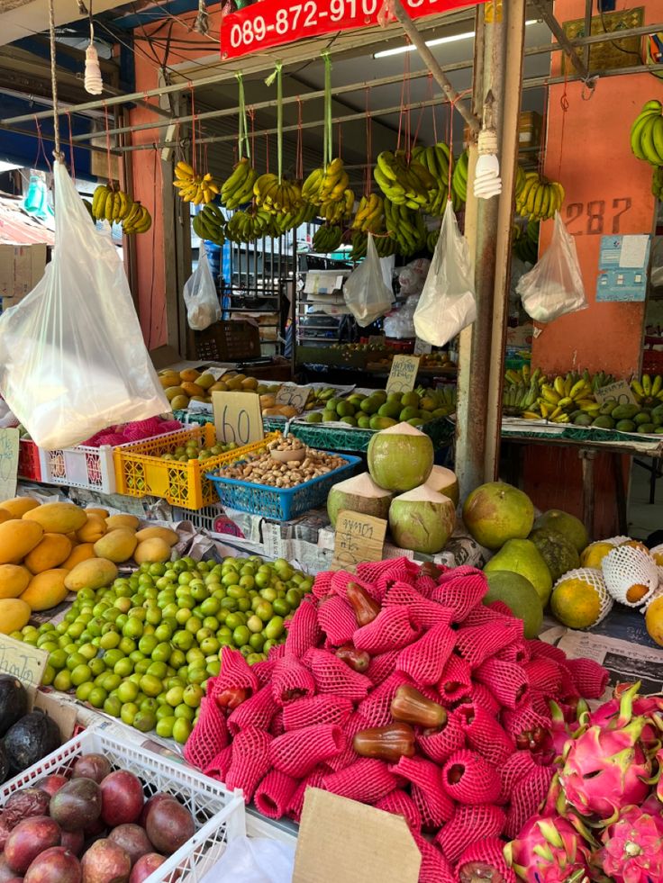 an outdoor market with fruits and vegetables for sale