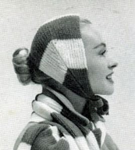 an old photo of a woman wearing a knitted hat and scarf with her mouth open