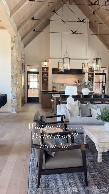 a living room filled with furniture and a piano in front of a kitchen area that has an open floor plan